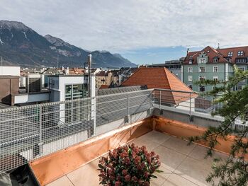 View over the roofs of the city Innsbruck, standing on the terrace of the panorama room