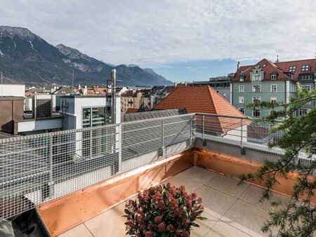 View over the roofs of the city Innsbruck, standing on the terrace of the panorama room