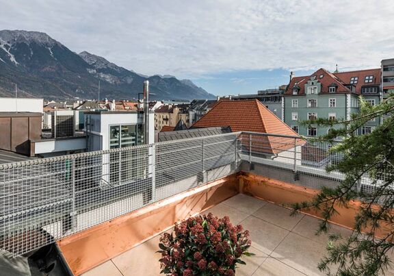 View over the roofs of the city Innsbruck, standing on the terrace of the panorama room