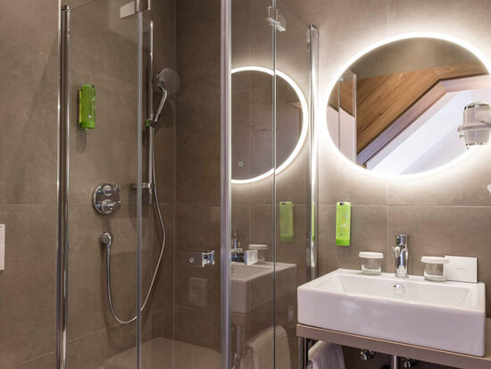 Detailed view of the bathroom of the suite with panorama in the hotel: shower, washbasin, toilet