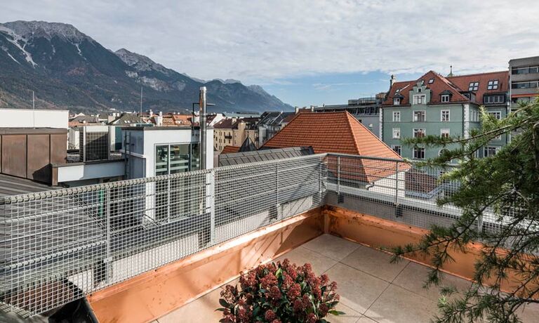View over the roofs of the city Innsbruck, standing on the terrace of the panorama room